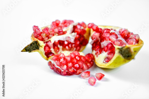 Pomegranate fruit with seeds on white background