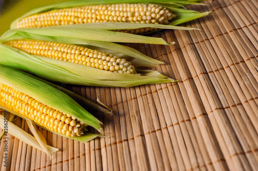 Corn cob, wooden background, top view, agriculture Corn cob, wooden background, top view, agriculture