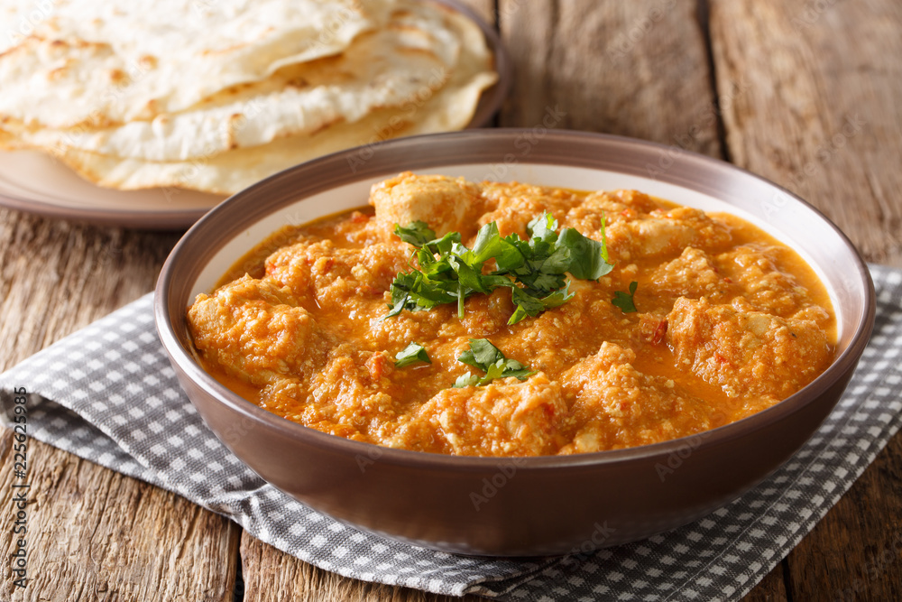 Delicious Indian chicken changezi in a spicy sauce served with flat bread close-up. horizontal Delicious Indian chicken changezi in a spicy sauce served with flat bread close-up. horizontal