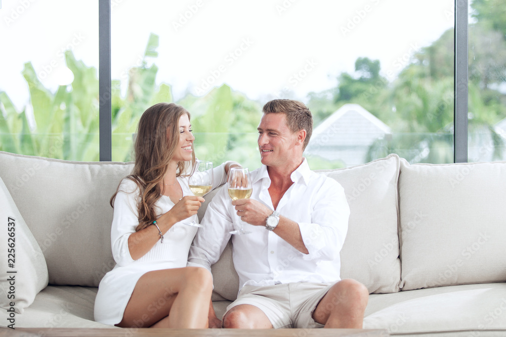 portrait of nice young couple drinking wine in summer house environment portrait of nice young couple drinking wine in summer house environment