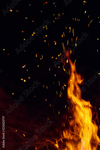 Night bonfire with sparks. Fire background with copyspace