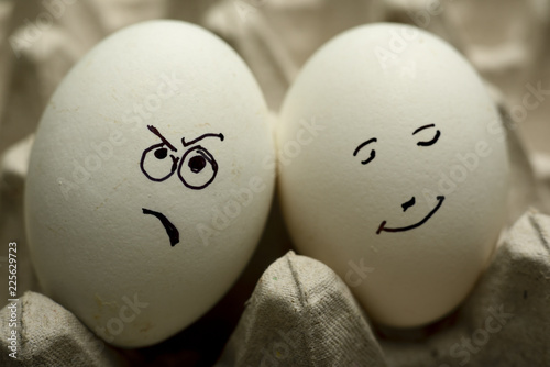 Close-up of Eggs with funny faces in the package
