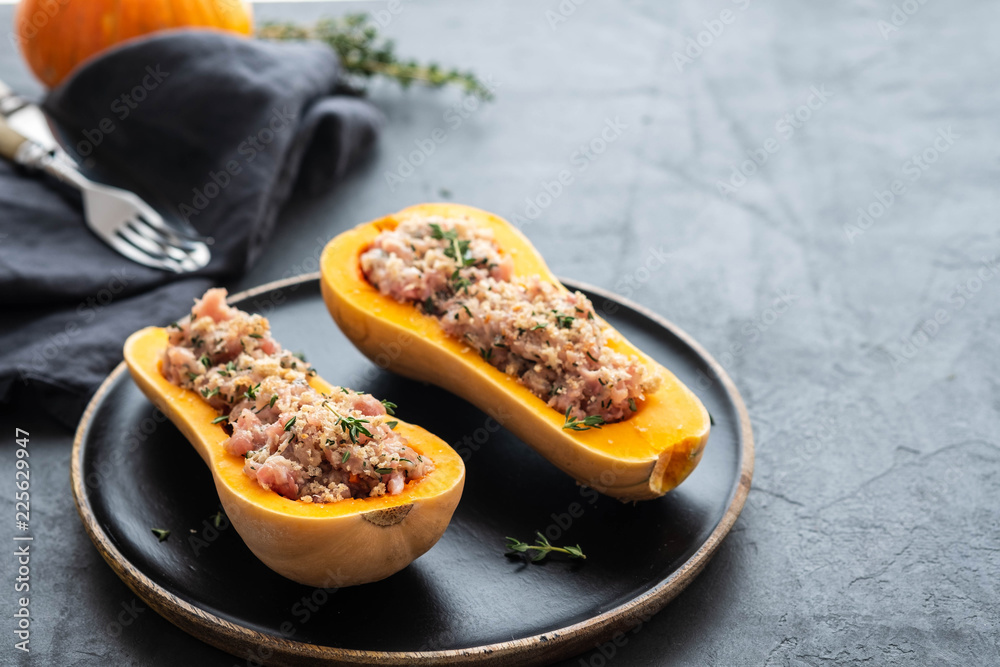 Pumpkin with minced meat with thyme, garlic on a black plate. Healthy seasonal autumn cuisine. Copy space. Pumpkin with minced meat with thyme, garlic on a black plate. Healthy seasonal autumn cuisine. Copy space.
