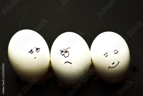 Egg represents human face isolated against black background