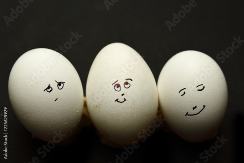 Egg represents human face isolated against black background