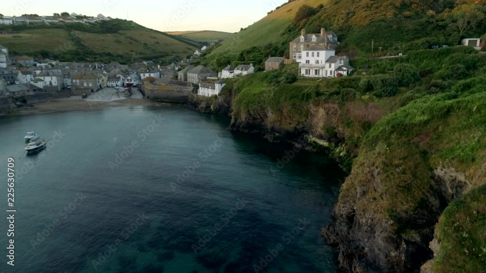 Drone descends beside cliffs in Port Issac Cornwall Drone descends beside cliffs in Port Issac Cornwall