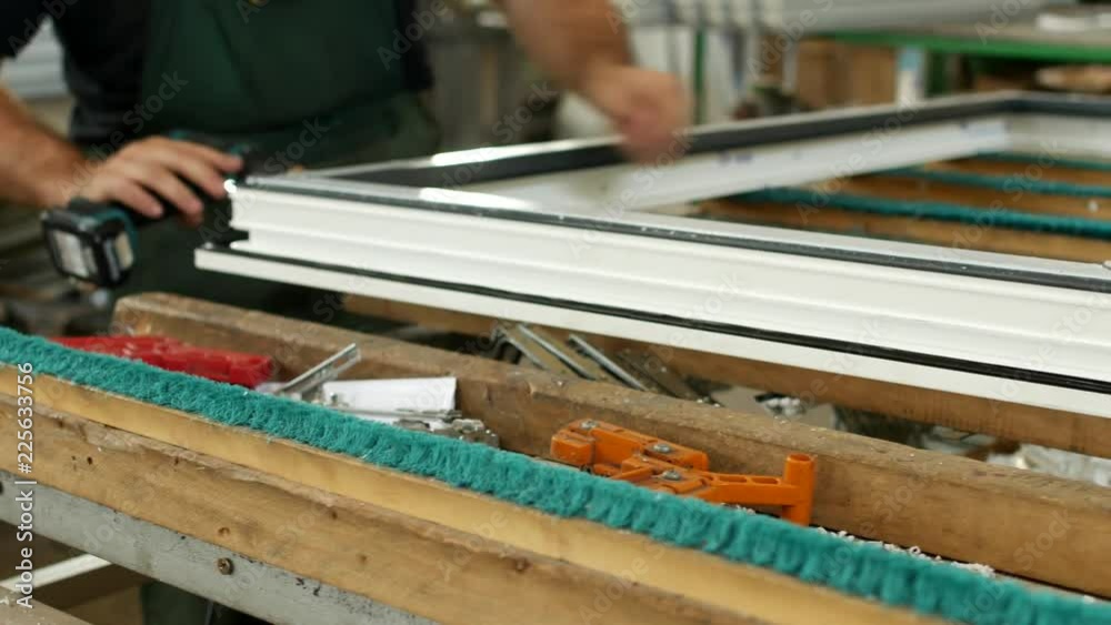Production and manufacturing of pvc windows, the male worker assembles ...
