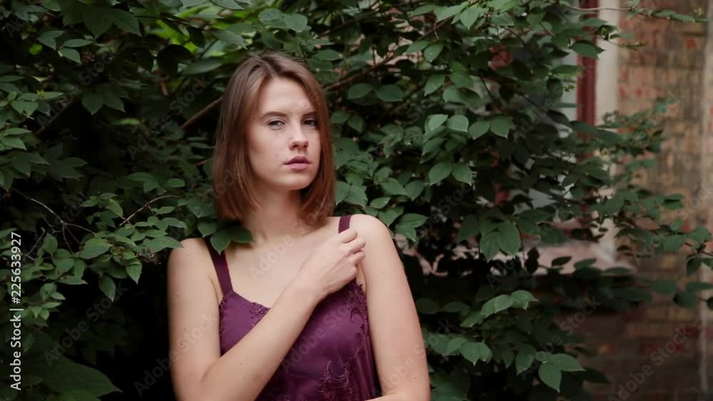 Very beautiful girl stands in bushes and poses. Very beautiful girl stands in bushes and poses.