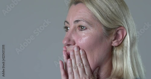 Woman closeup face being shocked and concerned photo