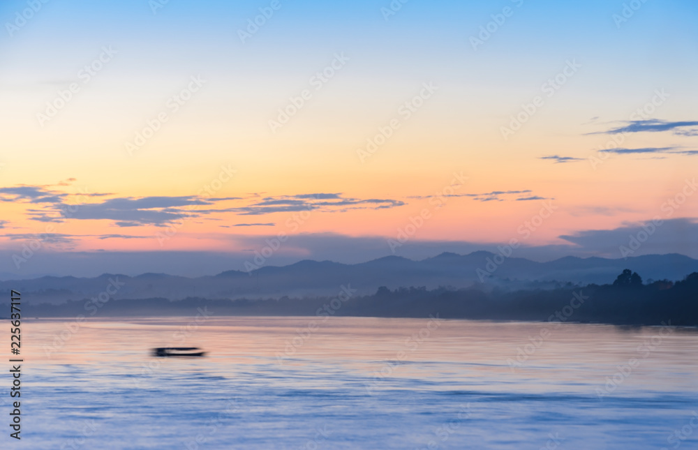 Abstract blurred nature sea and mountain landscape at sunset