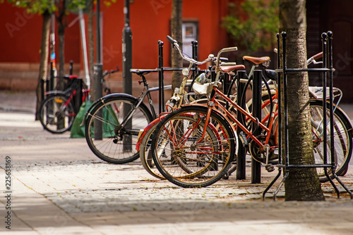 Bicycles parked on bike parking on old cobblestone street of Stockholm, Sweden