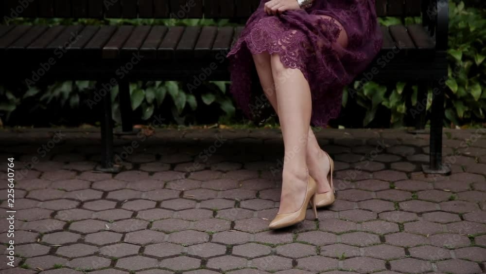 Very beautiful and sexy girl sitting on a bench in the park. Very beautiful and sexy girl sitting on a bench in the park.