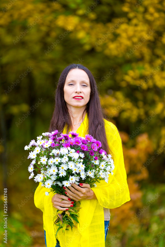 Beautiful woman with a bouquet in the autumn Park Beautiful woman with a bouquet in the autumn Park