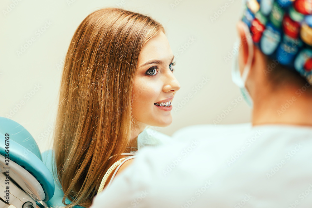 Fototapeta premium Dentist examine female patient with braces in denal office.