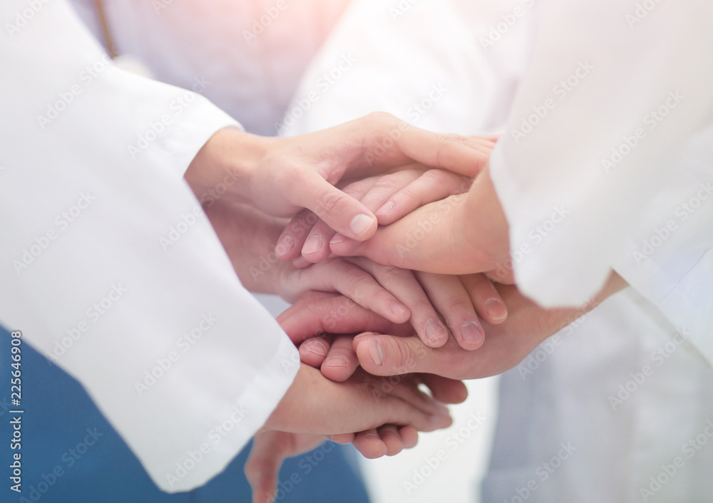 closeup.Small group of doctor team joining hands, closeup.Small group of doctor team joining hands,