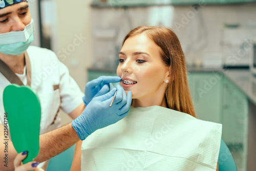 Dentist showing result of treatment for the patient.