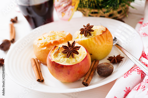 Stuffed baked apples with cottage cheese, raisins and almonds for Christmas on a white background. Xmas food dessert.