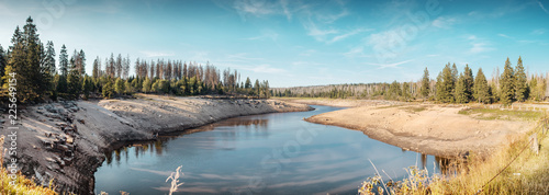 Panorama summer sun view of a historic mountain dam lake with beautiful blue sky. Oder Dam, Odertalsperre, National park Harz in Germany, Harz Mountains.