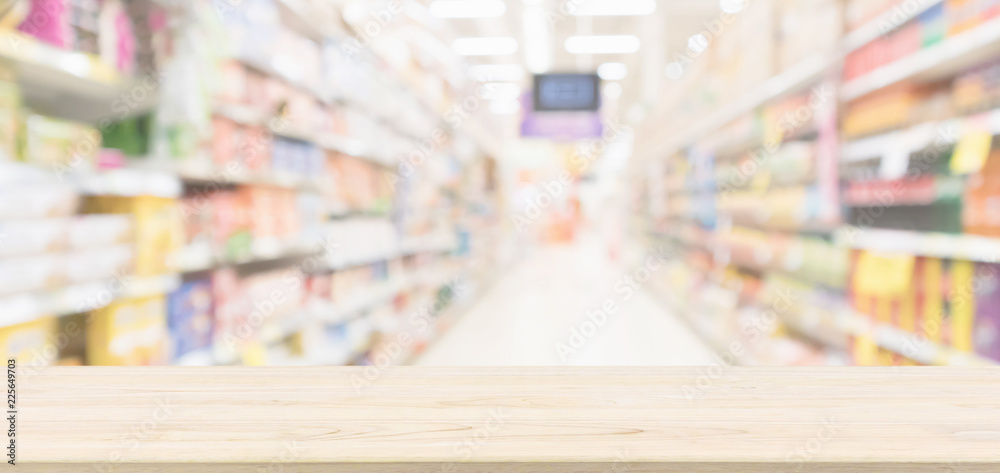 Fototapeta premium Wood table top with supermarket aisle blur background for product display