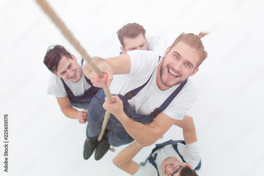 view from the top.smiling engineer ,climbing up the rope view from the top.smiling engineer ,climbing up the rope