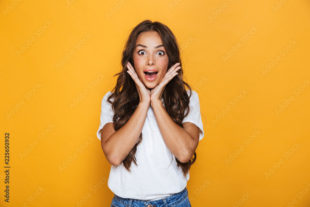Emotional young pretty woman posing isolated over yellow background. - obrazy, fototapety, plakaty 