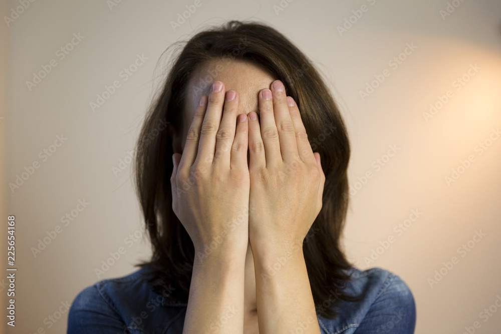 Beautiful women hiding behind her hands. Beautiful women hiding behind her hands.