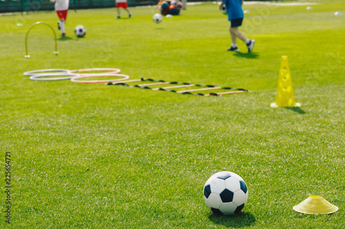 Physical Education Class. Soccer Training Session on the Grass Sports Field. Football Training Equipment. Traditional Soccer Ball  Speed and Agility Training Ladder  Cones. Kids Playing Sports Outdoor