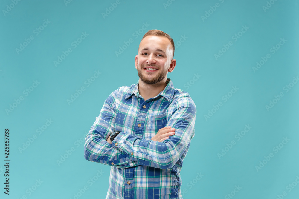 Happy business man standing and smiling isolated on blue studio background. Beautiful male half-length portrait. The human emotions, facial expression concept. Happy business man standing and smiling isolated on blue studio background. Beautiful male half-length portrait. The human emotions, facial expression concept.