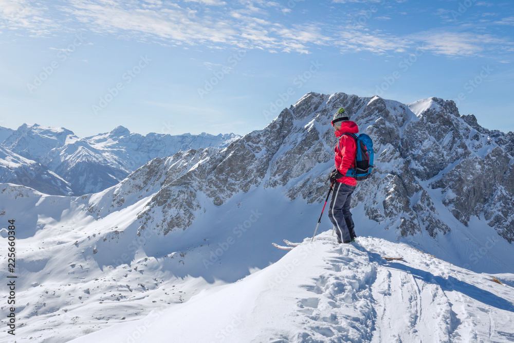Male ski tourer enjoying the view on a summit in the alps Male ski tourer enjoying the view on a summit in the alps