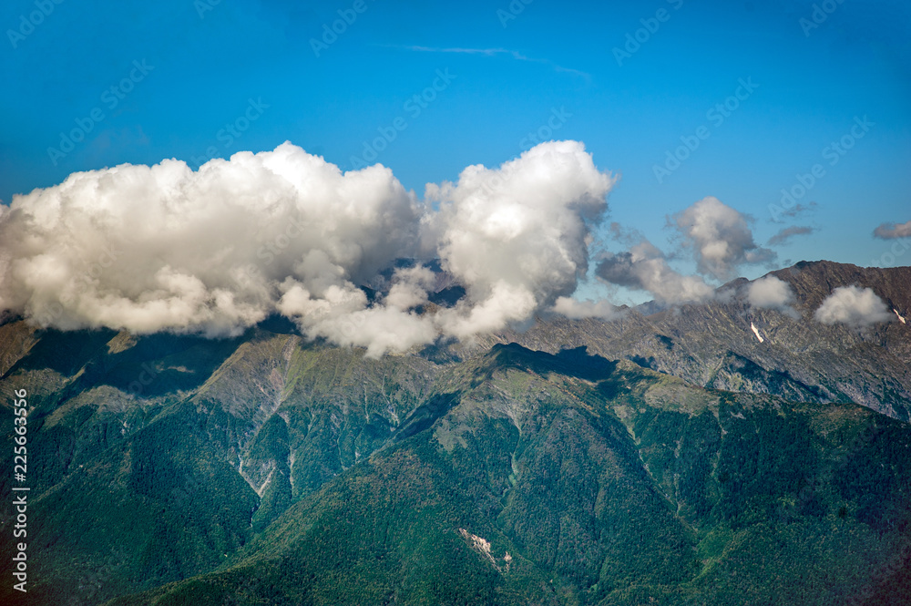 Rain clouds envelop the tops of the mountains