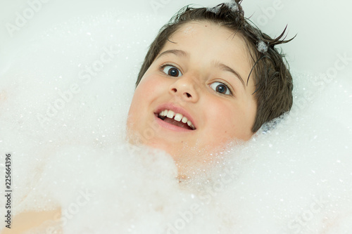 funny boy in soapy foam as in snow