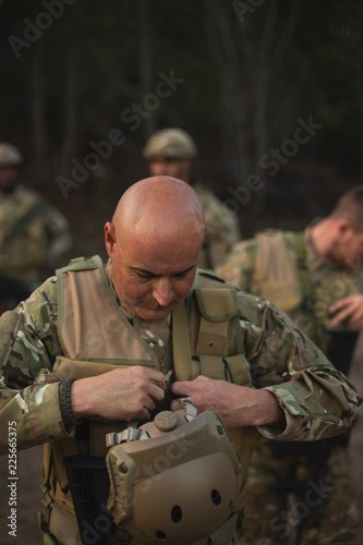 Military soldier wearing bulletproof vest photo