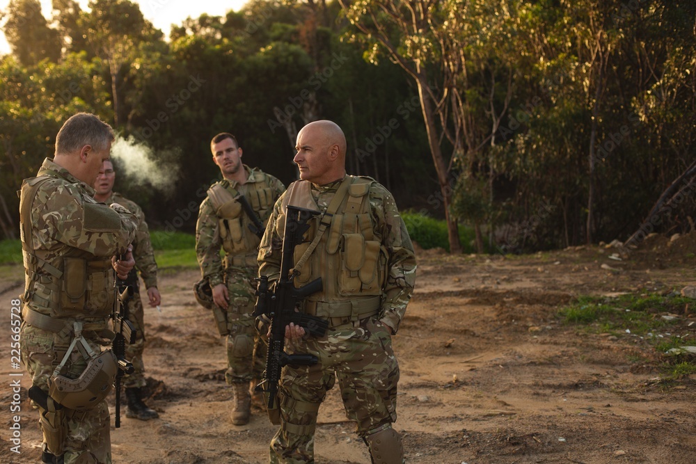 Military men talking outdoors Military men talking outdoors