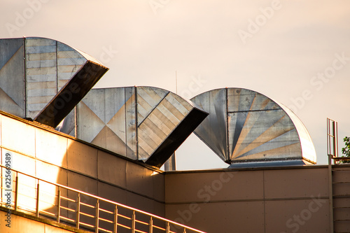 Roof with modern square ventilation ducts at sunset