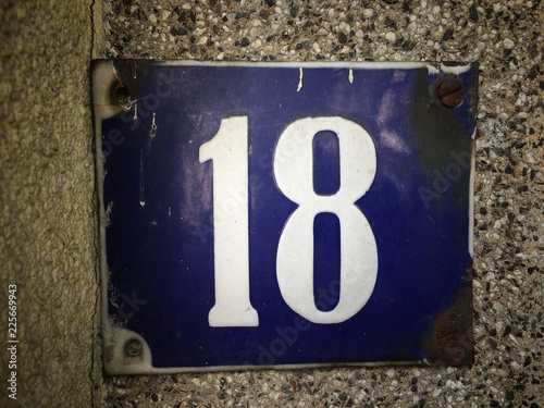 Vintage grunge square metal rusty plate of number of street address photo