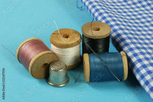wooden spools with colored cotton threads for sewing, vintage
