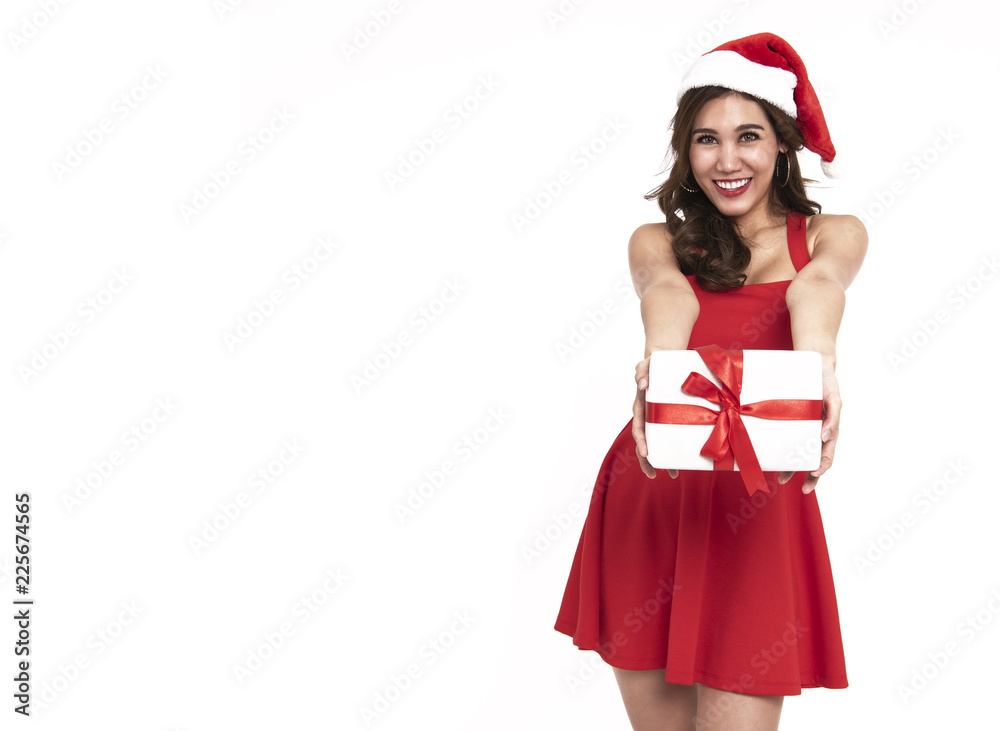 Cheerful young woman in red dress santa holding gift box for christmas isolated on white background. Cheerful young woman in red dress santa holding gift box for christmas isolated on white background.