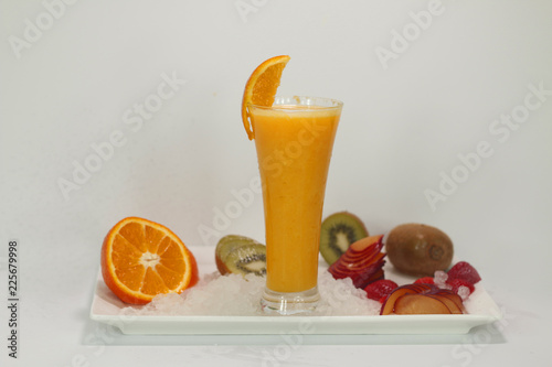 juice cup with fruit slices on a white plate with ice