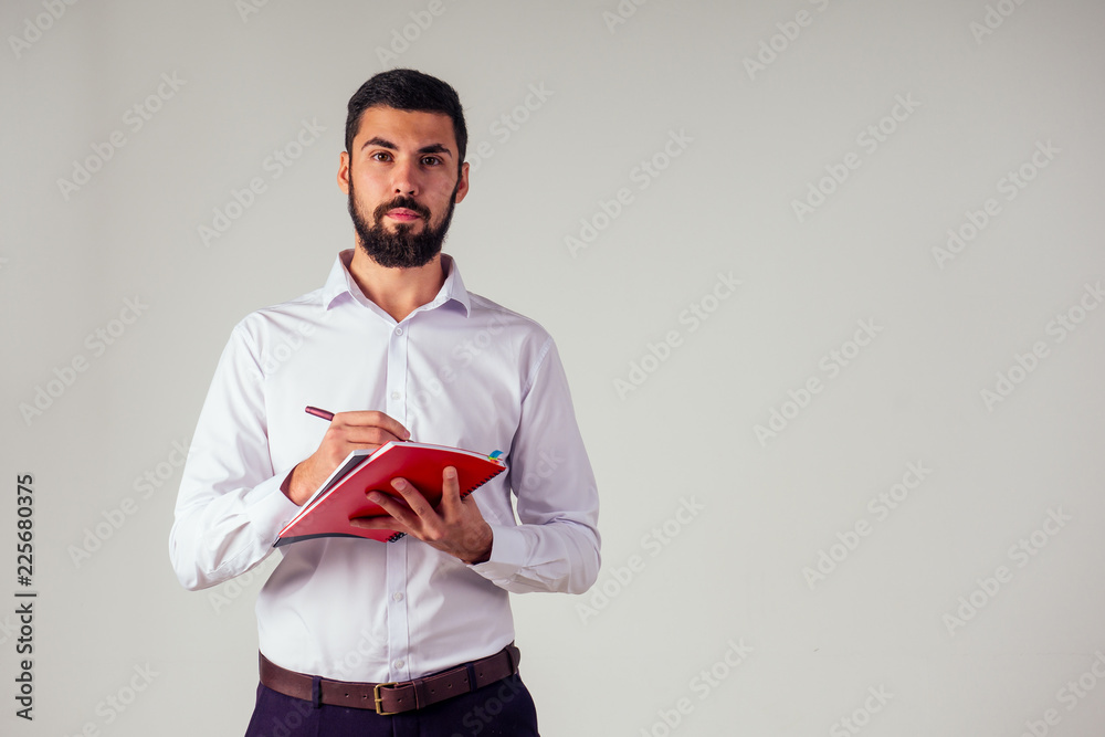 businessman in white collar shirt with pen and notepad . in a studio. concept of business coach inspiration and ideas motivation businessman in white collar shirt with pen and notepad . in a studio. concept of business coach inspiration and ideas motivation