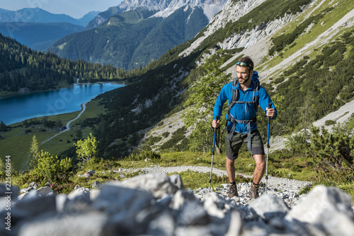 Austria, Tyrol, Young man hiking in the mountains at Lake Seebensee photo