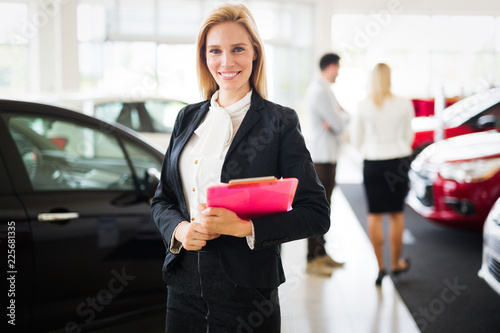 Professional gorgeous saleswoman at car dealership in formal wear. Super consultant and manager © NDABCREATIVITY