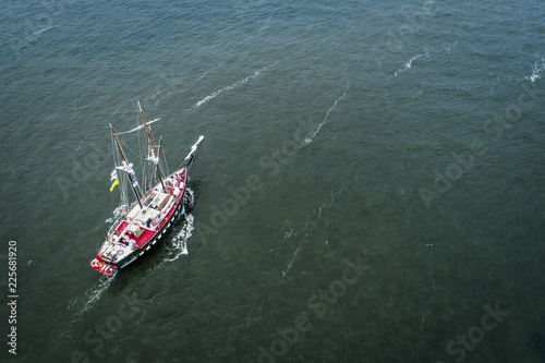 Old sail boat approching Port of Montreal on the St-Lawrence River photo