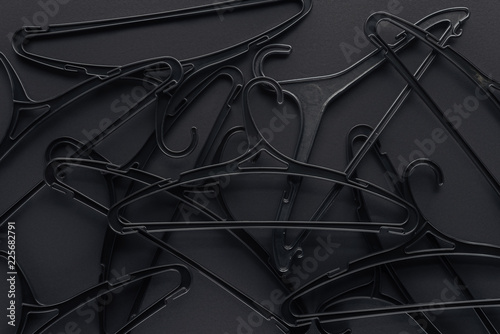 background with black hangers on black, top view for black friday