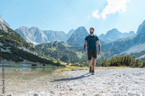 Austria, Tyrol, Man hiking at Seebensee Lake photo