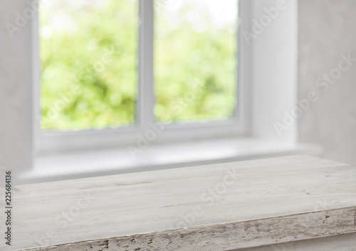 Desk of free space with blurred summer window as background