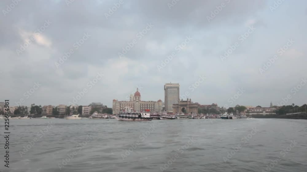 Shot of Mumbai landmarks - Gateway of India, The Taj Mahal Hotel from a speed boat Shot of Mumbai landmarks - Gateway of India, The Taj Mahal Hotel from a speed boat