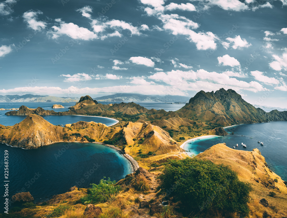 Bays, mountains, cloudy sky. Aerial shot. Padar. Spectacular panoramic overview the bays and mountains of the amazing Padar island of the Komodo National Park. Indonesia. Exotic place to visit.