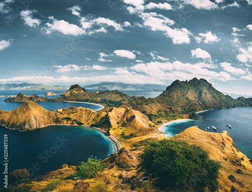 Bays, mountains, cloudy sky. Aerial shot. Padar. Spectacular panoramic overview the bays and mountains of the amazing Padar island of the Komodo National Park. Indonesia. Exotic place to visit. © Goinyk