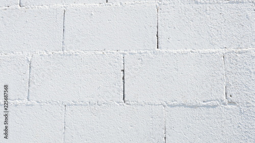 Fondo con textura de pared o muro de ladrillos de bloque pintados de blanco photo