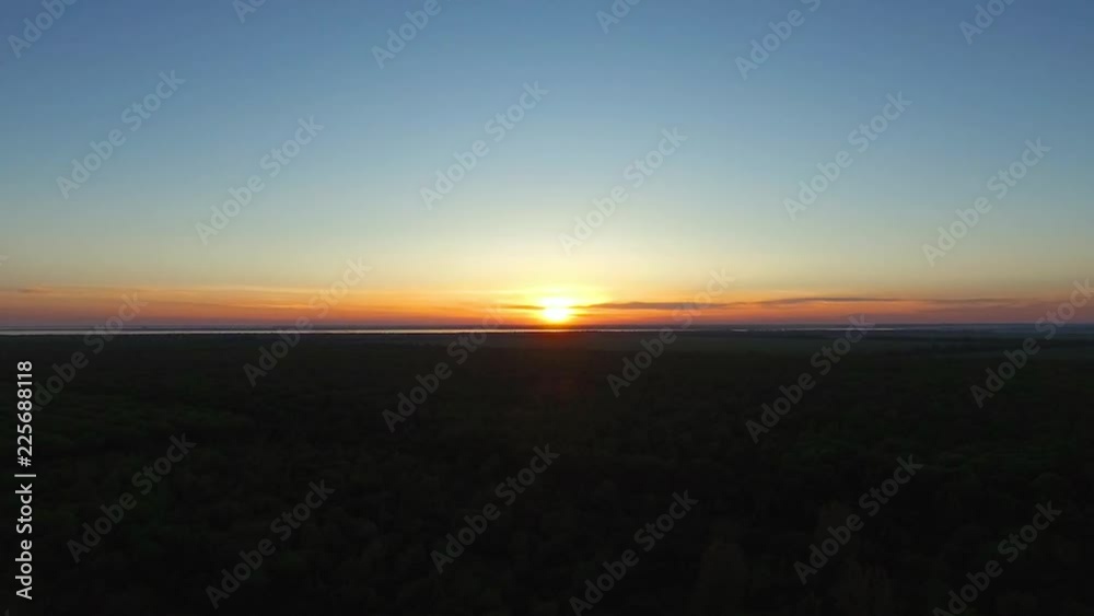 Landscape sunset over the forest far on the horizon can be seen the sea Landscape sunset over the forest far on the horizon can be seen the sea